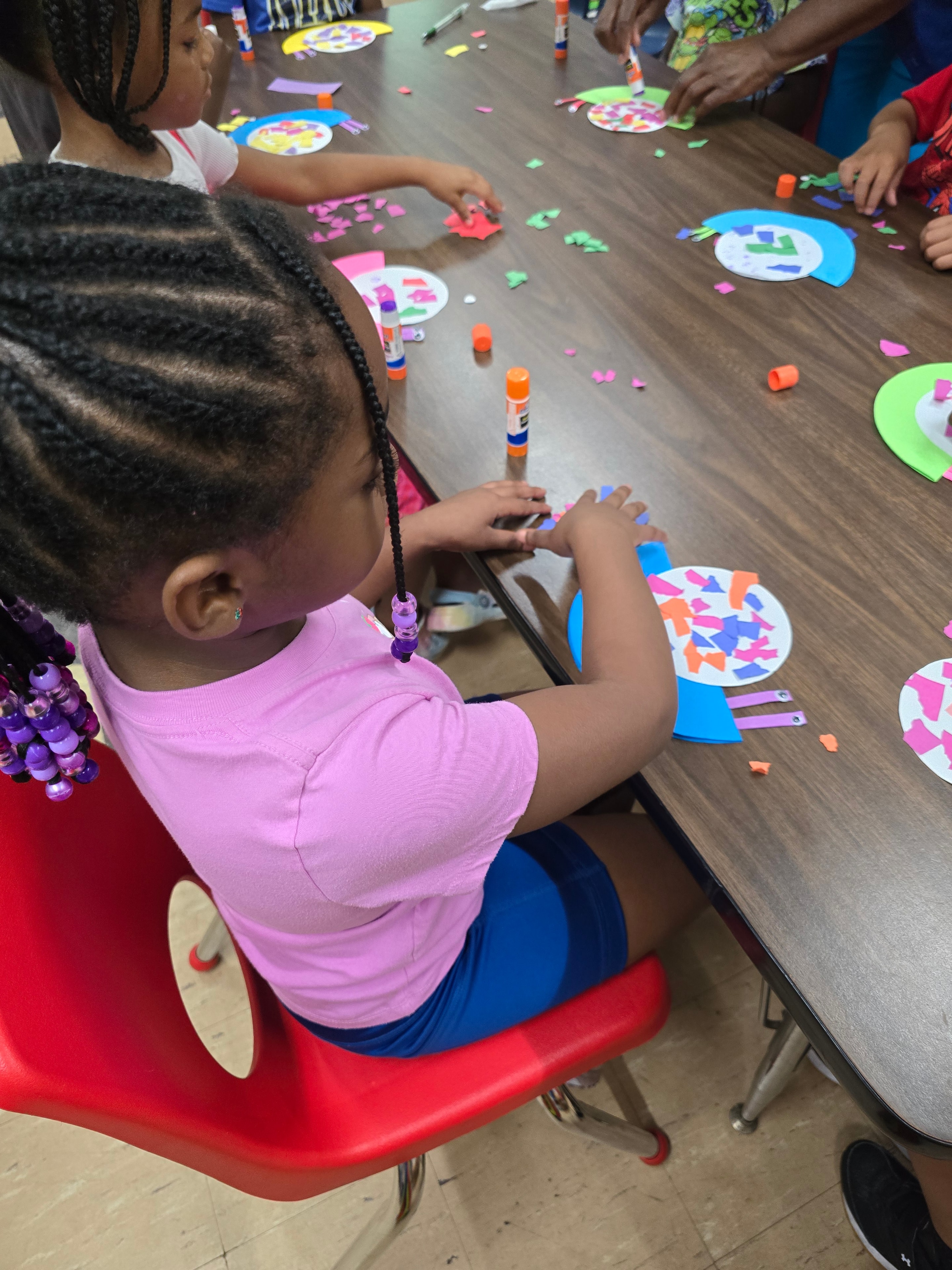 Teacher sitting with children at a table